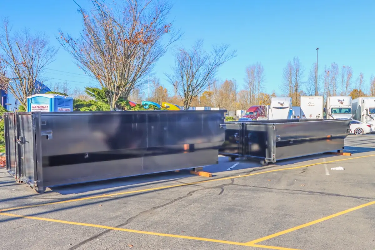 Professional dumpster rental service with roll-off container on residential driveway in Peoria Heights